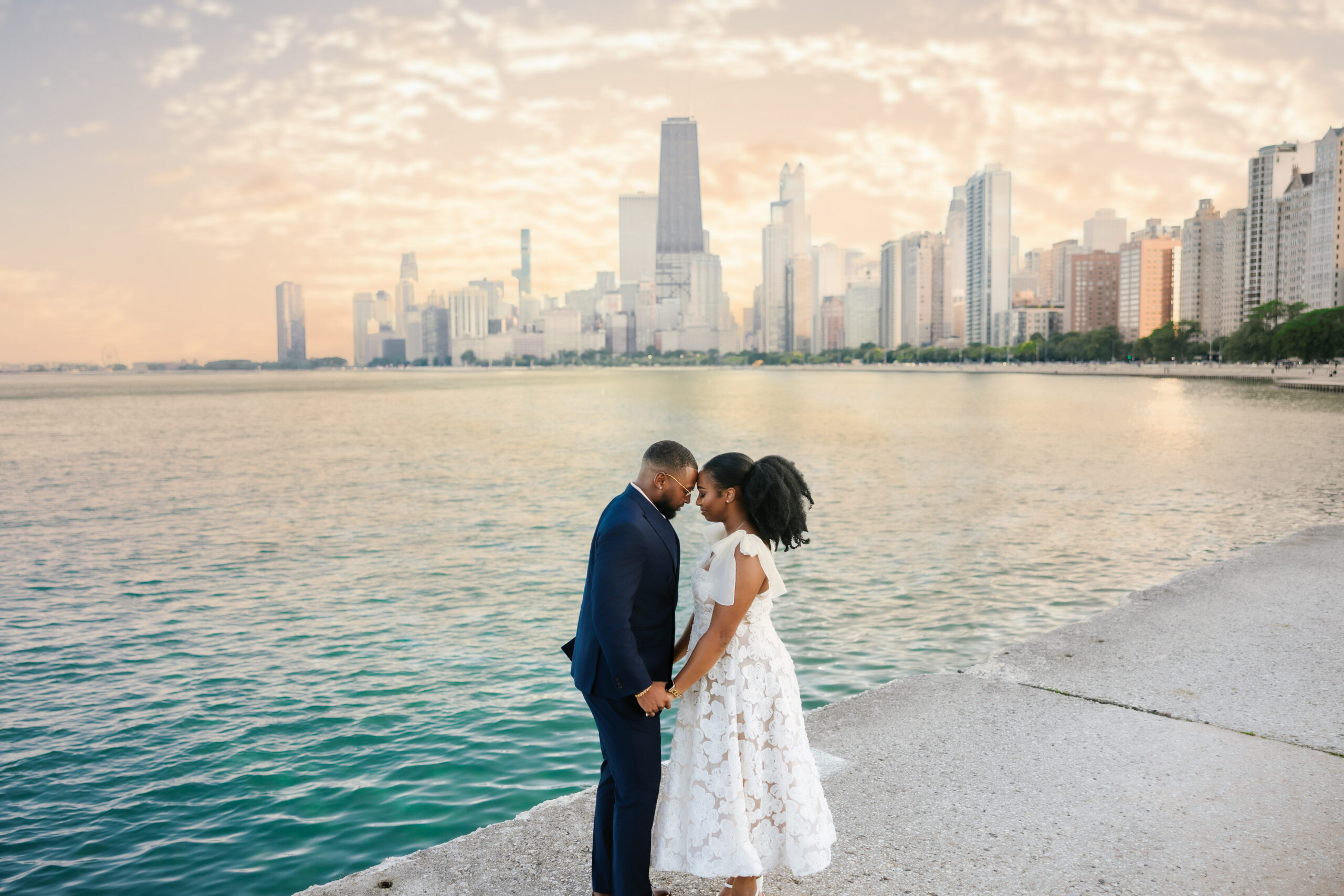 Golden LYT Photography capturing couple in love at North Avenue beach during their chicago engagement session.